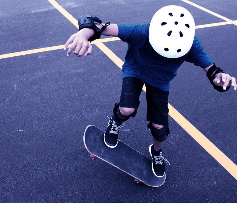 a young boy doing a trick on a skateboard