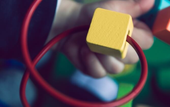a photo of a child's hand holding a toy block